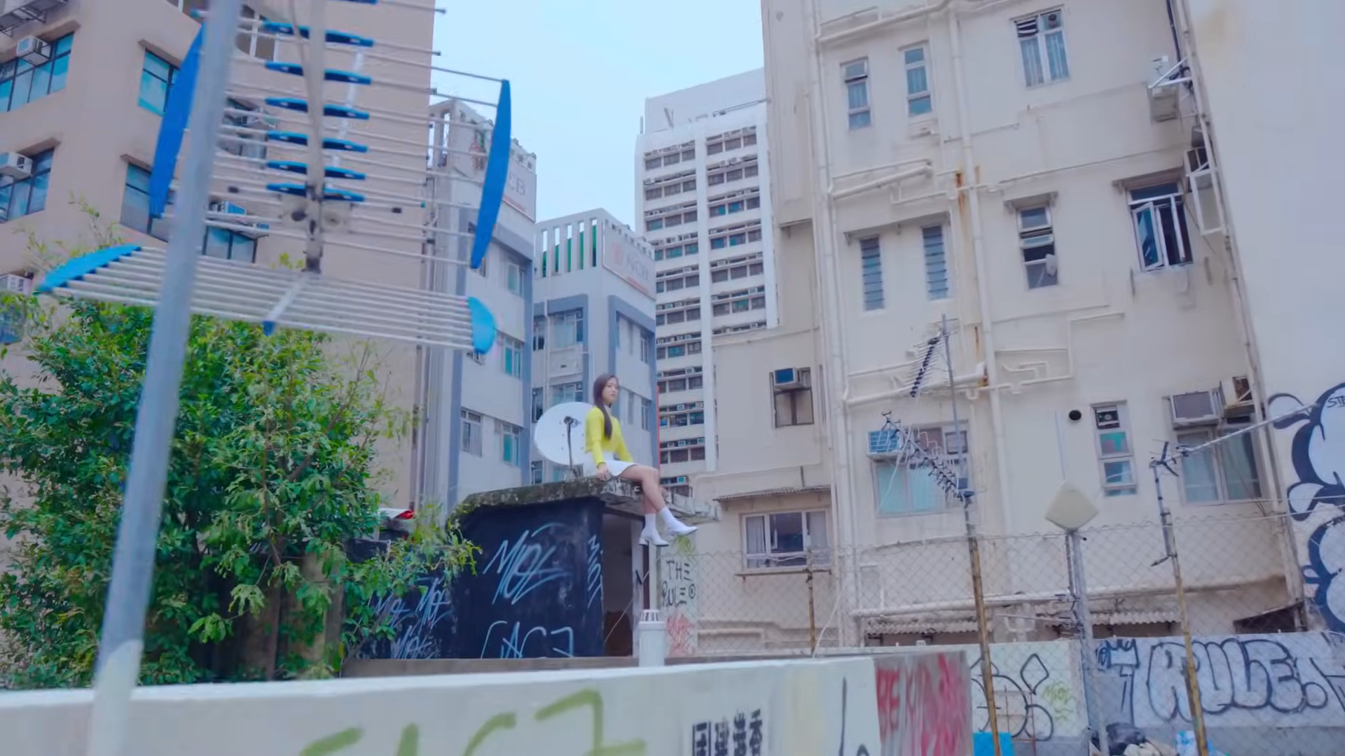 Hyunjin sitting next to a satellite.